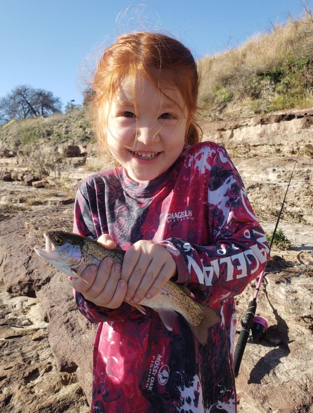 small girl holding fish
