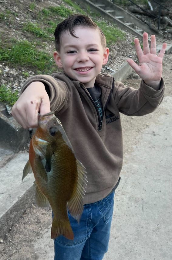 small boy holding fish
