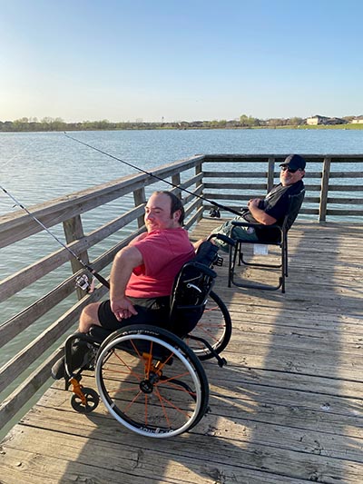 two people in wheelchairs fishing
