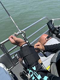 person with fishing pole strapped to left arm