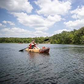 person kayaking on lake