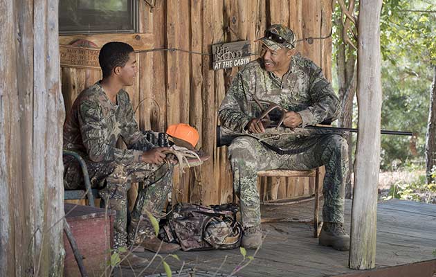 Father and son prepare for hunt