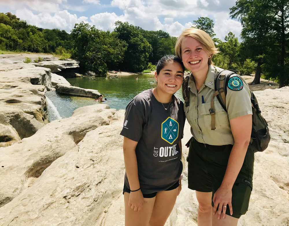 Intern and Park employee in park.