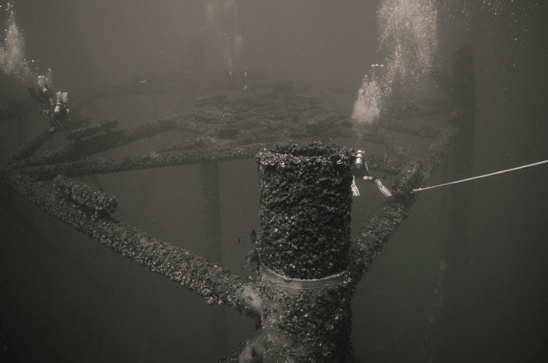 Divers explore the top end (closest to surface) of a standing eight-pile jacket.