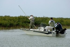 boat being poled through shallow water