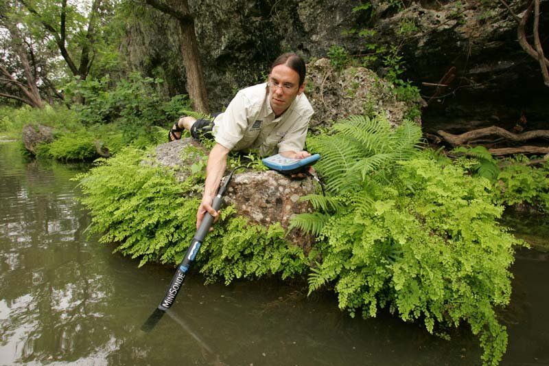 Water quality regulator works to enforce clean water laws to protect our waters from pollution, an image of Working and Careers in Water and Aquatic Science from the book Texas Aquatic Science by author Rudolph Rosen.