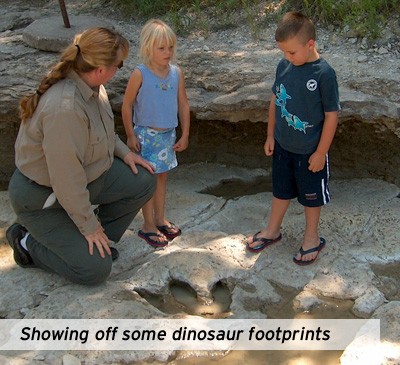 Kathy shows off some dinosaur footprints to kids