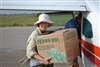2 Volunteers Help Unload Falcons in Cardboard Boxes