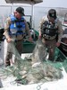 Game Wardens Examine Illegal Nets, Fish