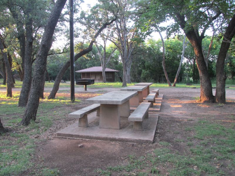 The shelters are scattered around this picnic area, which has a large waist-high grill.