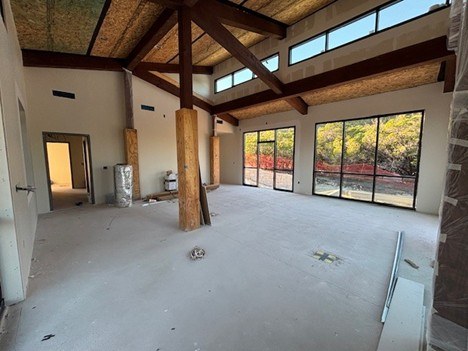 Inside of nature center, which is empty but partially finished with wood and windows in place.