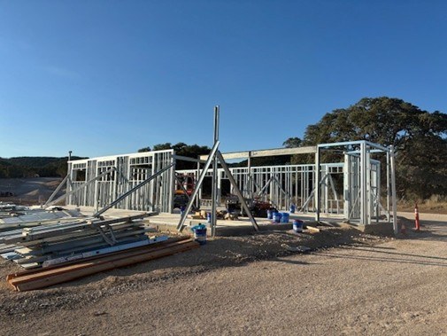 Metal frame of building stands on a slab