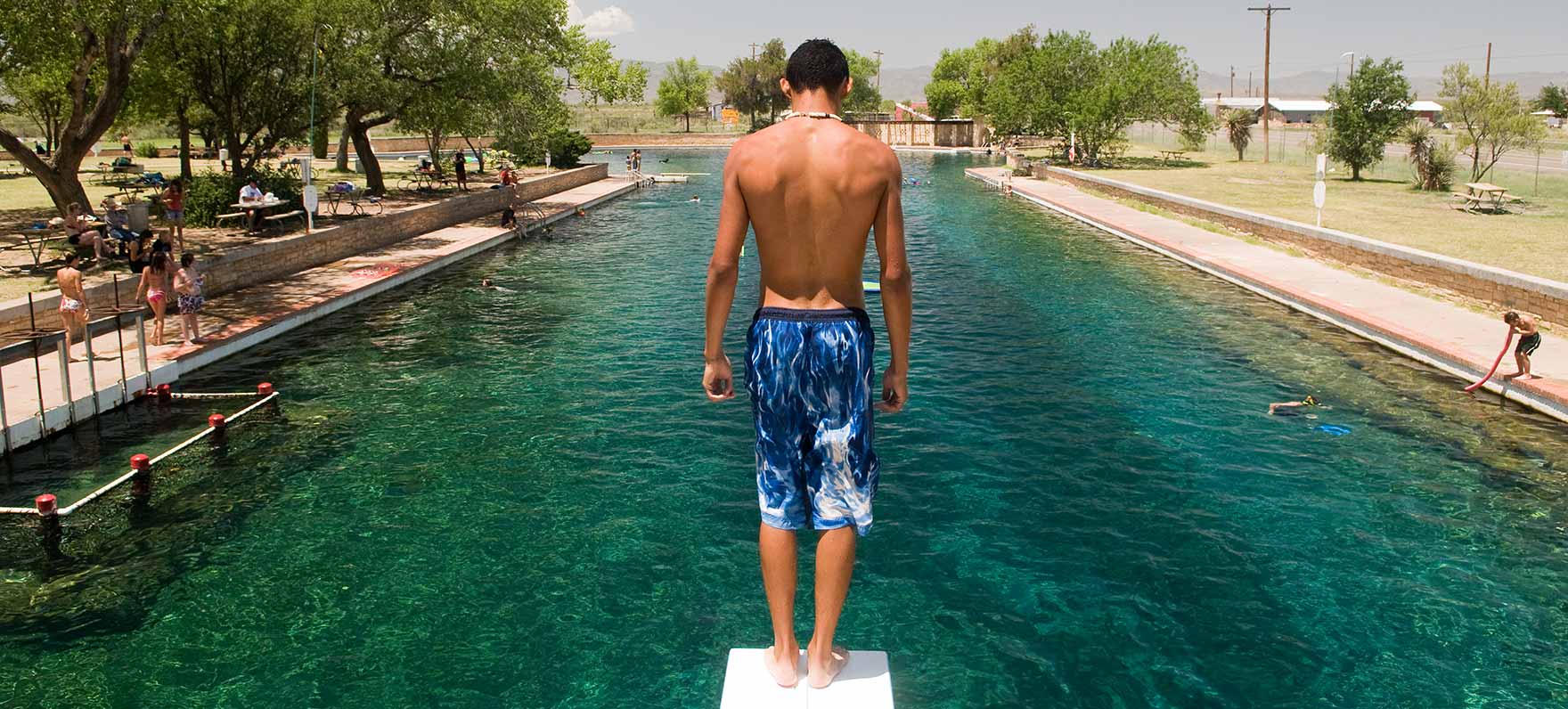 A man on the diving board at Balmorhea State Park