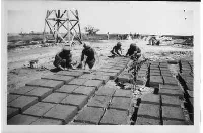 CCC workers laying adobe bricks out to dry.