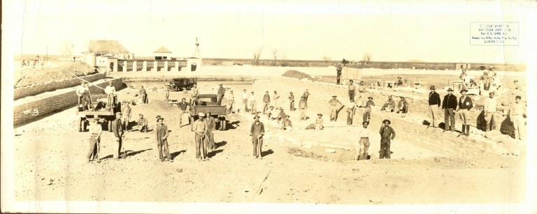 CCC workers and supervisors pose in the bed of the pool.