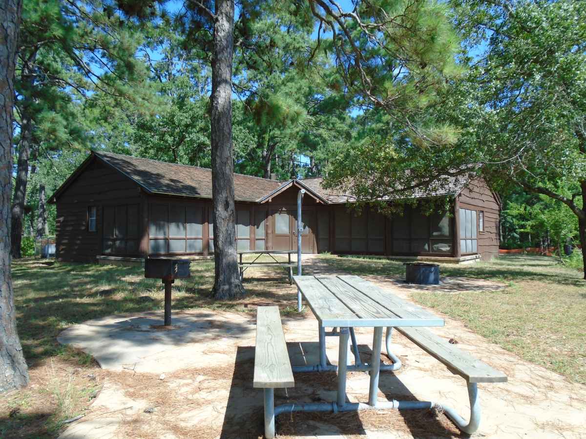 Cabin 12 also has two picnic tables, a fire ring with a grill, an upright grill and a lantern post in the back.  Photo taken in July 2015.