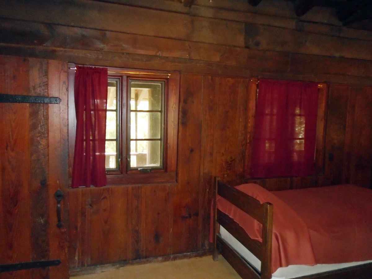 The two bedrooms in Cabin 6 each have one double bed, and there is a single bed in the living area.   