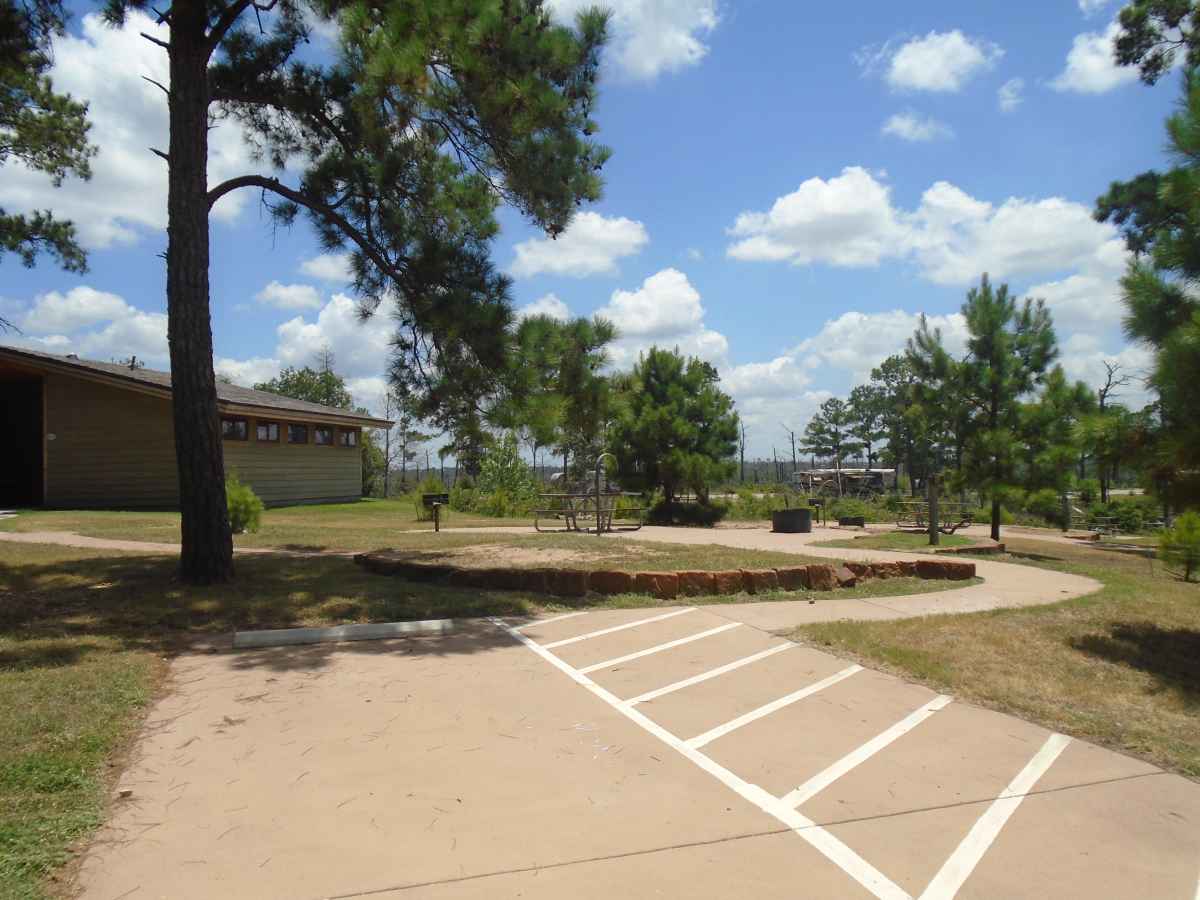 Accessible Campsite #27 is close to the bathrooms and has a raised fire ring, upright grill, lantern post, picnic table and paved walkways designed for use with a wheelchair.  