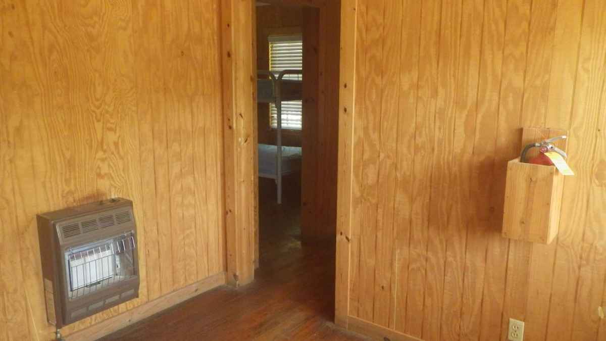 A group barracks living area looking towards one of the bedrooms.  
