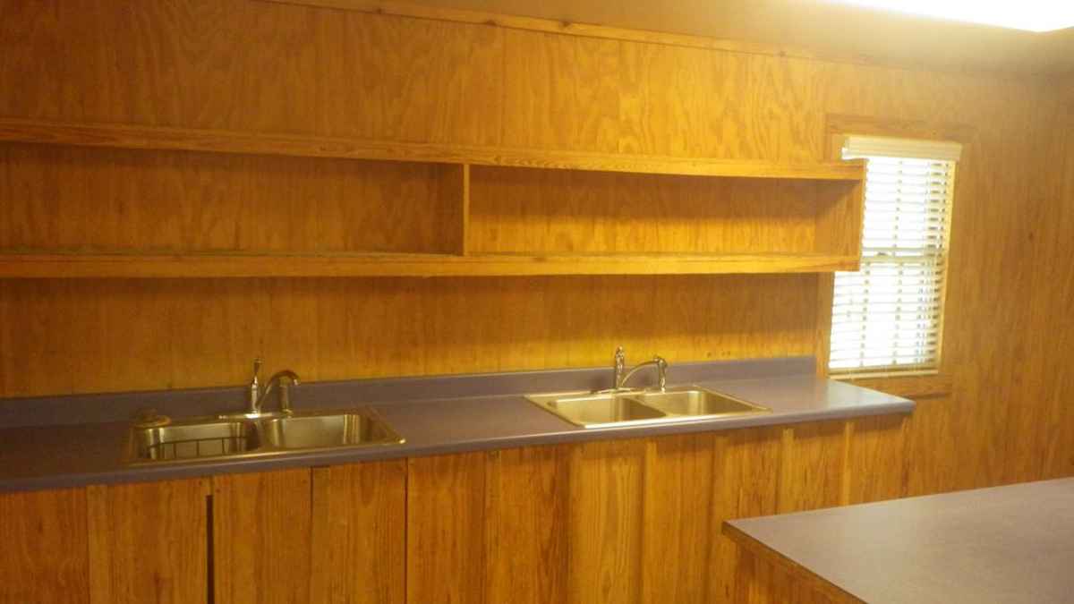 two sinks and plenty of shelf and prep. space are in the kitchen. 