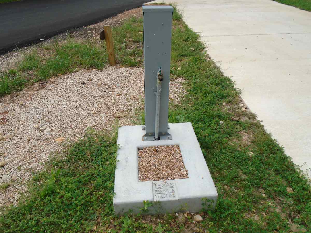 The water spigot and 20/30-amp electric plug at Campsite #1 in Cozy Circle Camping Area. 