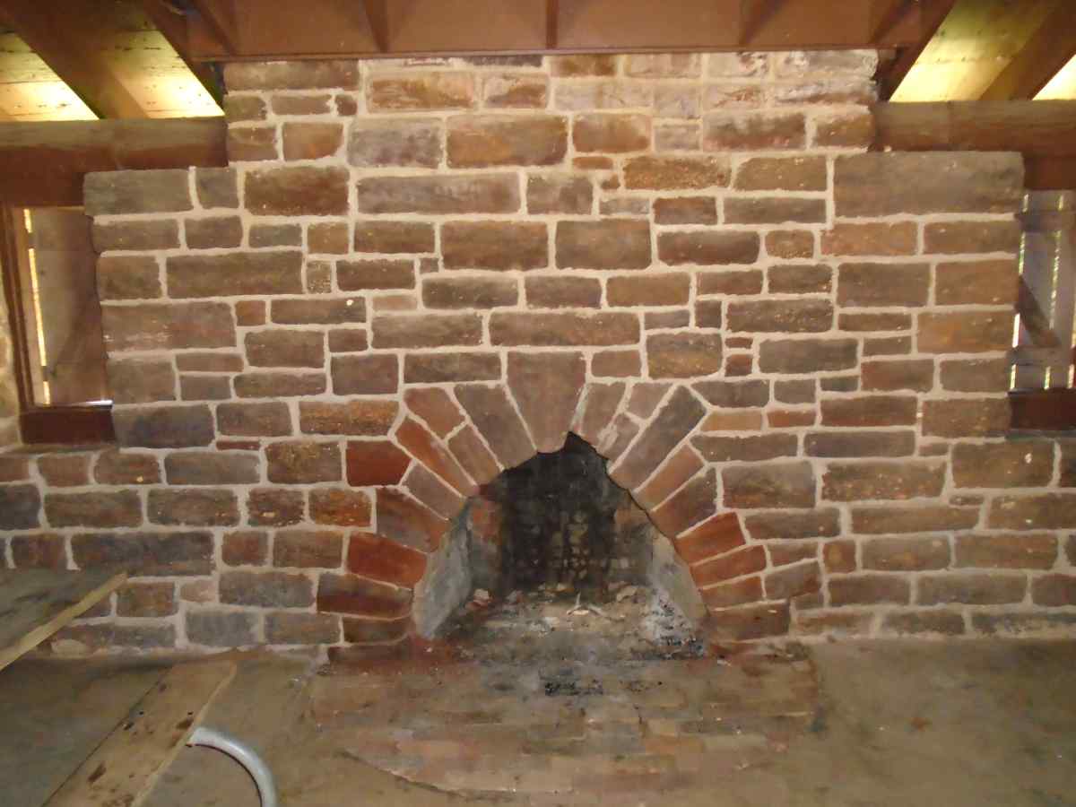 A covered fireplace inside the pavilion.