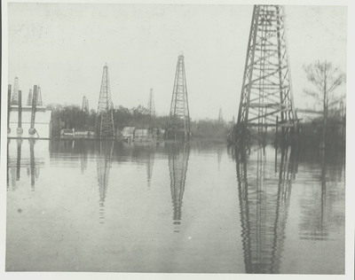 Oil rigs reflecting on the water of Caddo Lake