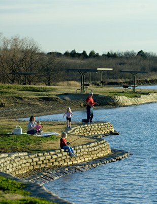 Family fishing on the banks of the lake.