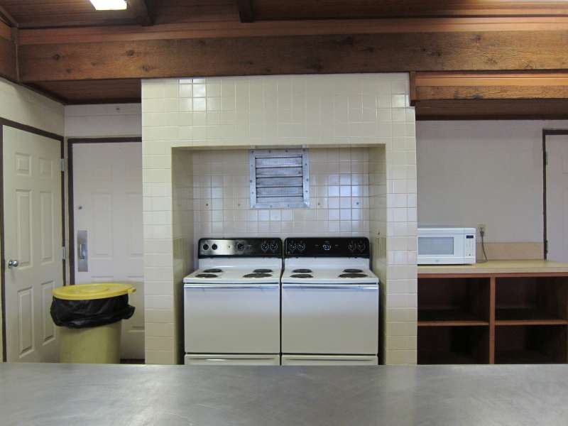 Two oven/stoves and a microwave oven are in the kitchen area.  
