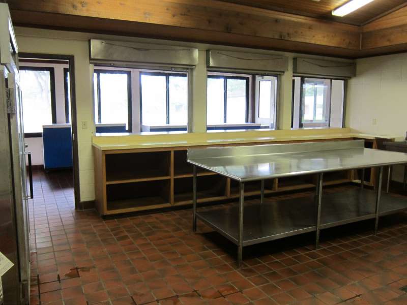 Lots of shelves, prep area, a commercial refrigerator, and serving area.  