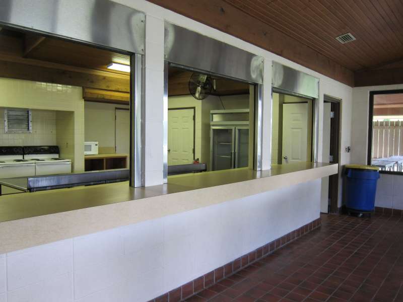 Lots of shelves, prep area, sinks. 2-oven/stoves, a microwave oven, a large refrigerator, a serving area, and the covered dining area just outside.  