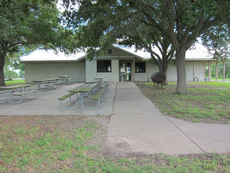 The back of the Group Rec. Hall has picnic tables and a BBQ grill. 