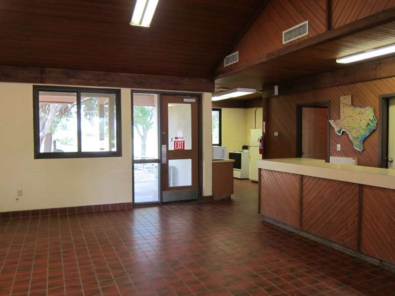 Inside the Group Rec. Hall with a view of the front desk and the kitchen.