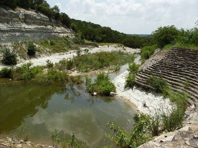 Multilevel spillway built with standing water at its base.