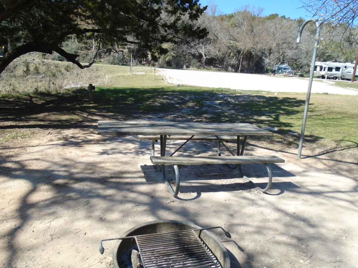 The short trail to Campsite 19 is unpaved but the site has a large cement slab and a wheelchair friendly picnic table.  