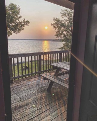 Sunset view of the lake from the desk of a cabin. 