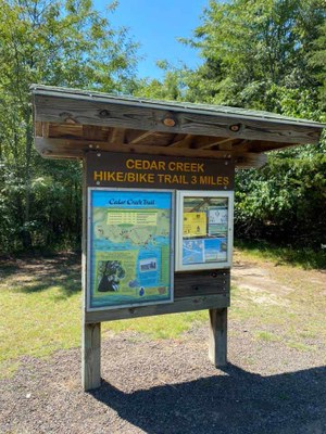 Sign showing a trail map of the Cedar Creek Trail