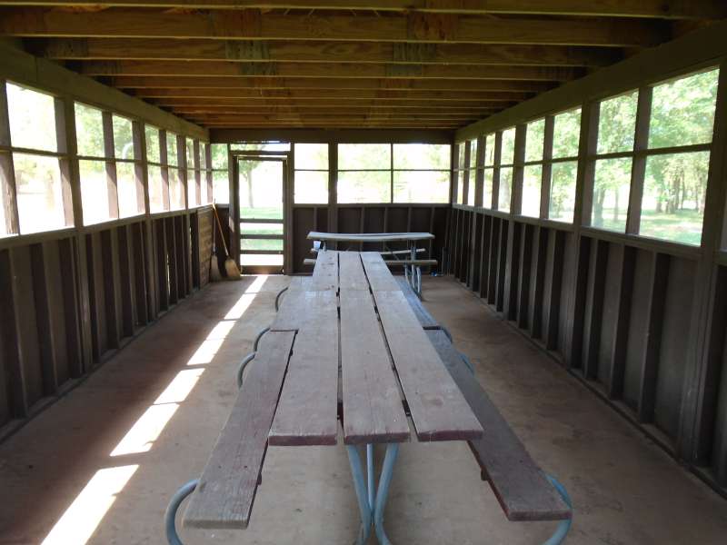 3-picnic tables are inside the screened pavilion. 