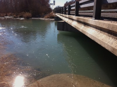Water flowing under bridge