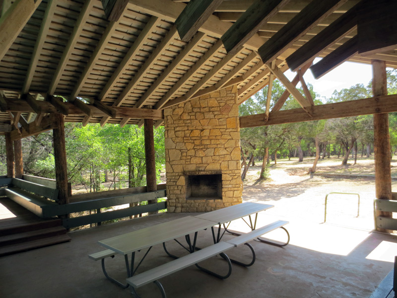 The pavilion has picnic tables and a fireplace.