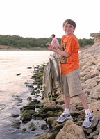 Boy holding stringer of fish