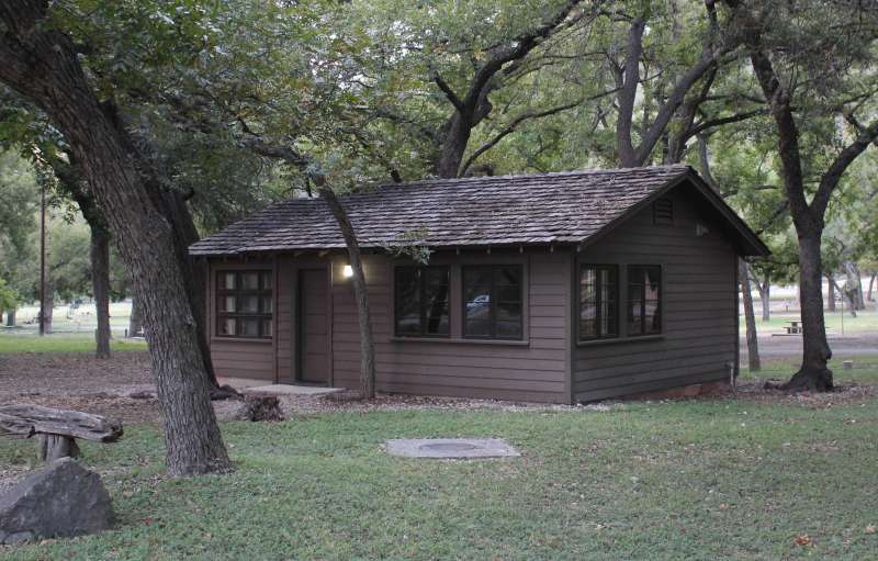 Outside a cabin without a fireplace. 