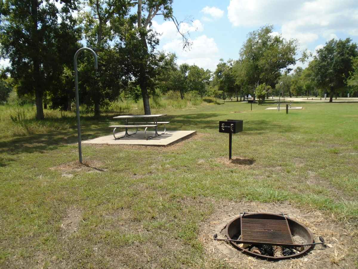 Full hookup campsite #2; all have a fire ring with a removable grill, waist high adjustable grill, picnic table, and a lantern post. 