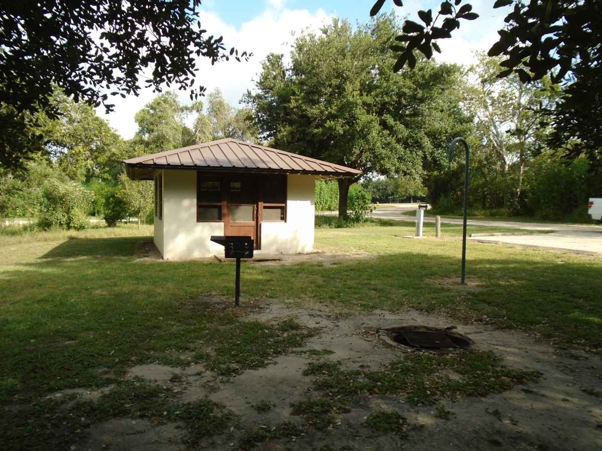 Screened Shelter #1; looking at the fire ring with a grate, the upright grill and the lantern post.  