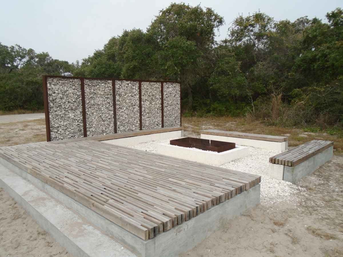 There is a large fire pit, with seating and a wind break.  