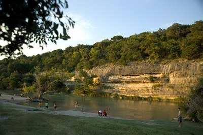 People scattered along and in the river.