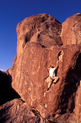 Rock climber on steep face.