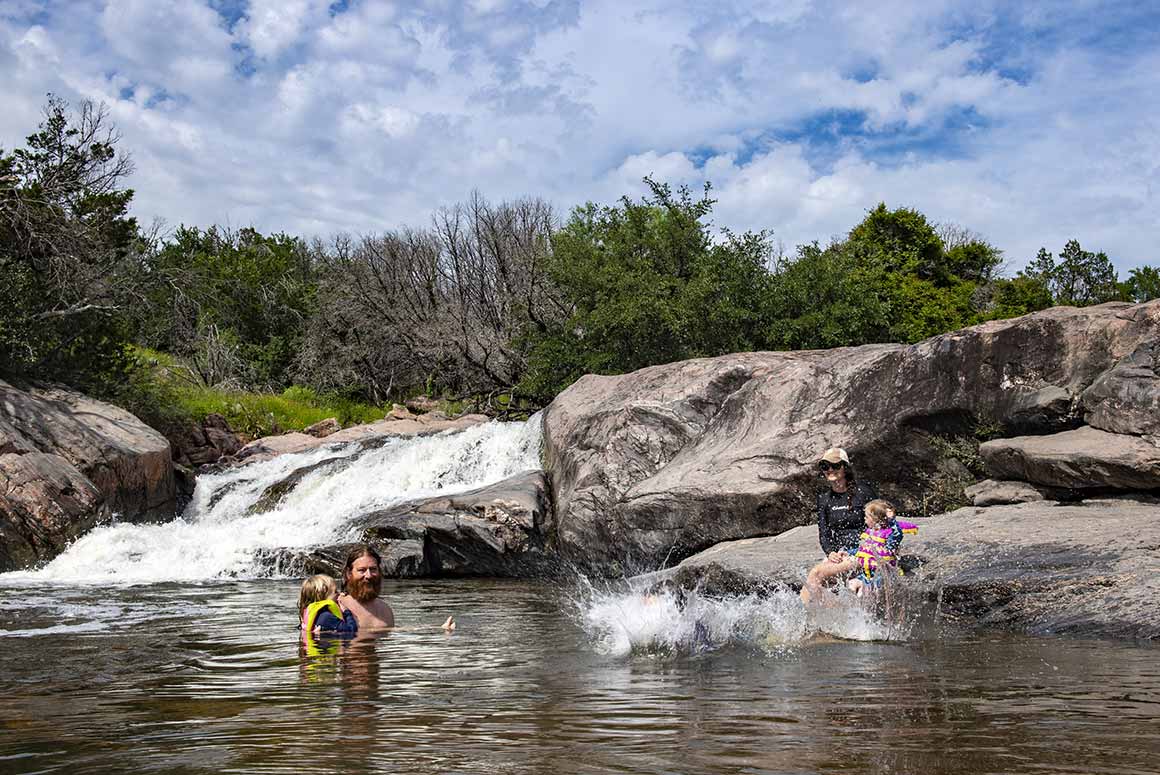 Family swimming Inks Lake