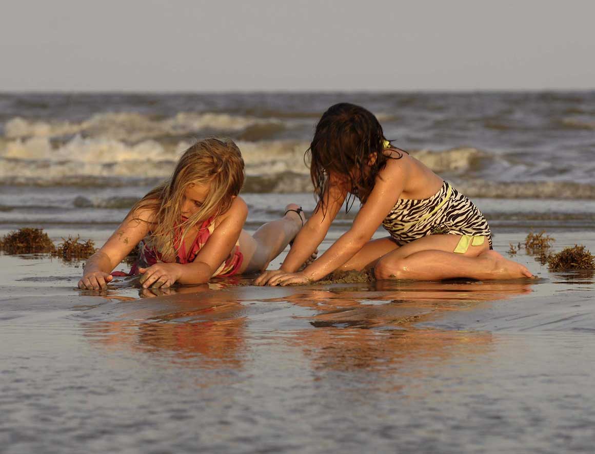 Girls playing in sand Galveston Island State Park