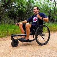 A man uses a GRIT wheelchair on a trail